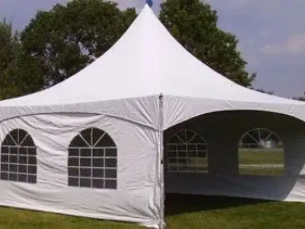 A white tent with windows on the side of it.