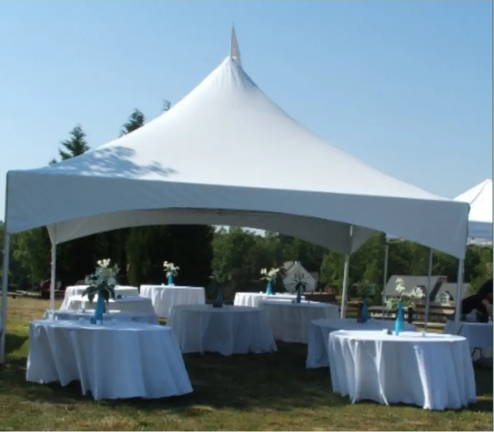 A white tent with tables and chairs around it.